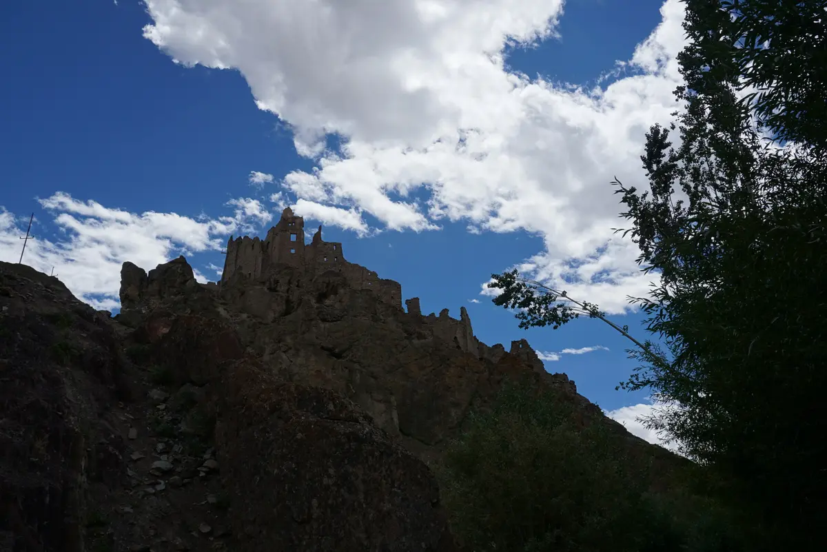 Silhouette of the ruined Chiktan castle on a rocky ridge