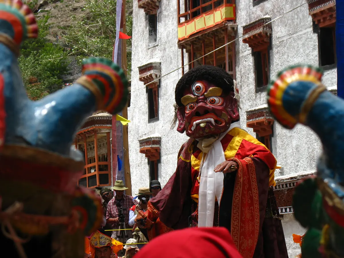 Masked dancers performing in the courtyard during the Hemis monastery festival