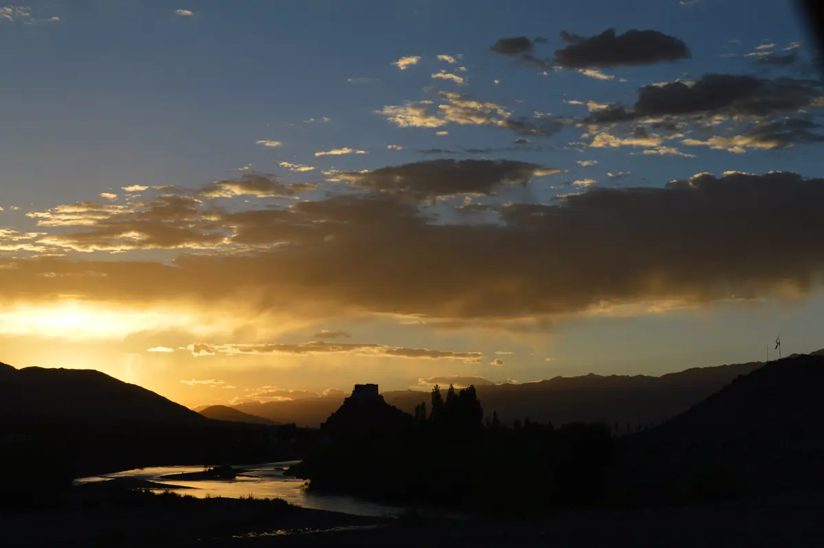 Sunset over the Indus river with mountains in silhouette