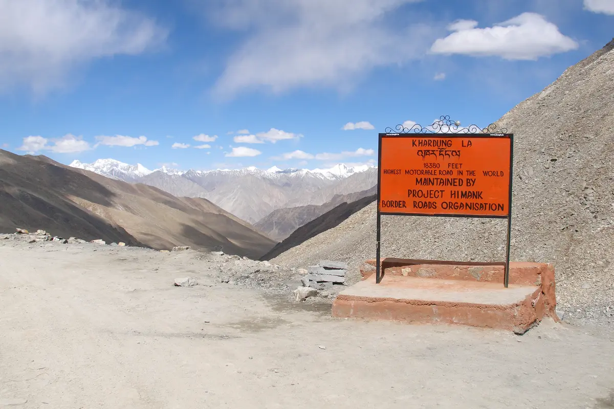 Khardung La signboard with mountain views behind