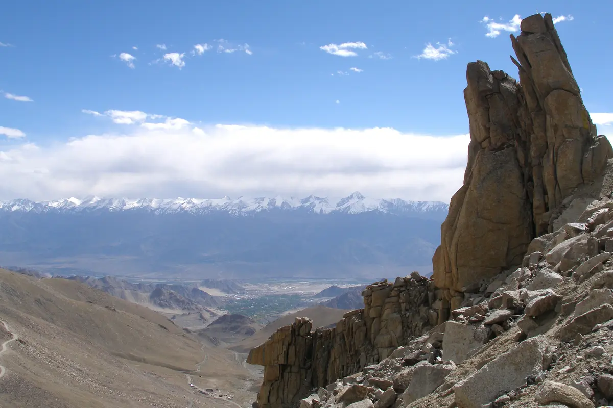 Rock pinnacle near Khardung La with the Indus valley and distant peaks beyond