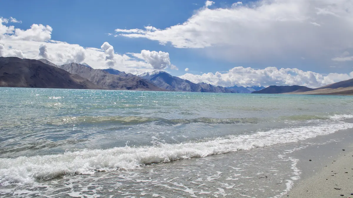 The shore of Pangong Lake with mountains behind