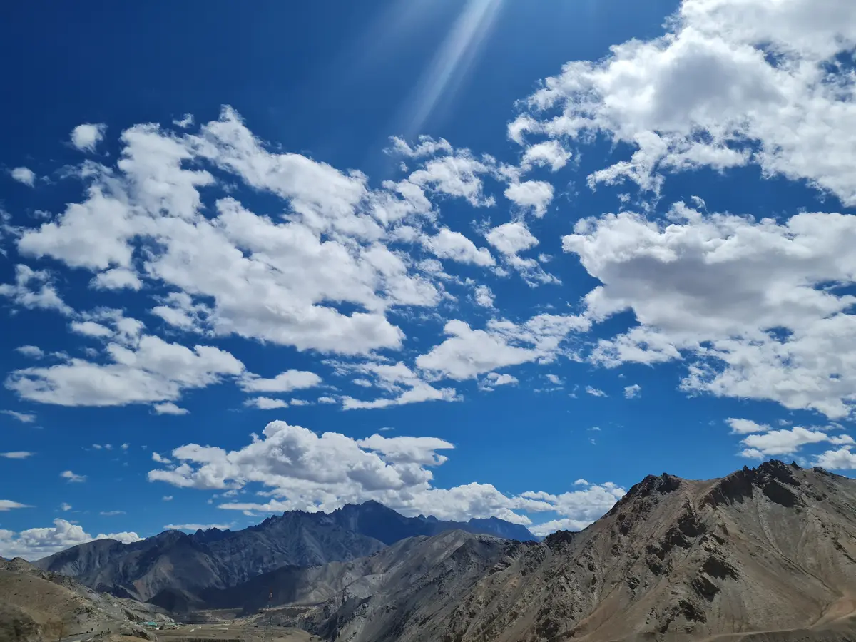Mountains under a cloudy blue sky along the Srinagar–Leh highway